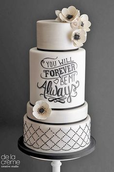 a three tiered cake with white flowers on top and the words you will forever be my always