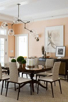 a dining room table and chairs with chandelier in the middle of the room