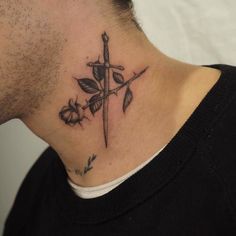 a man with a cross tattoo on his neck