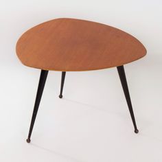 an oval wooden table with black legs and a brown top, on a white background