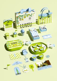 an assortment of green and blue items on a yellow tablecloth with the words loveu written in white