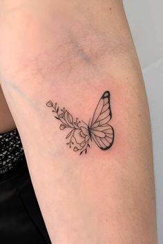 a small butterfly tattoo on the arm