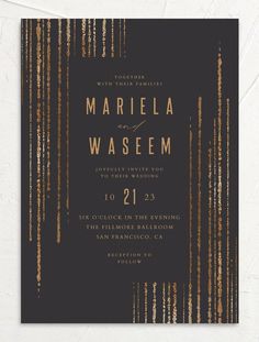 an elegant black and gold wedding card with metallic foil on the front, featuring vertical stripes