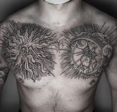 a man's chest with sun and moon tattoos on it