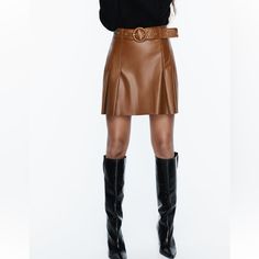 High Waisted Skirt With Self Belt Pleat Detail Back Hidden Inseam Zip Closure Whiskey Leather Pleated Mini Skirt For Work, Fall Season Belted Mini Skirt, Fall Leather Pleated Mini Skirt, Chic Pleated Leather Mini Skirt, Fall Belted Mini Skirt, Belted Mini Skirt For Fall, Fall Workwear Belted Pleated Skirt, Fall Mini Skirt With Belt, Chic Leather Pleated Skirt For Fall