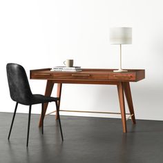 a wooden desk with a black chair next to it