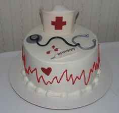 a white cake decorated with medical symbols and stethoscopes