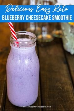 a blueberry cheesecake smoothie in a mason jar with a red and white striped straw