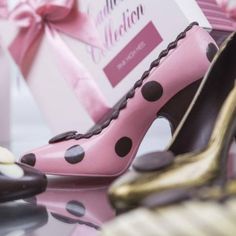 pink and black polka dot high heel shoes next to a gift box that says congratulations