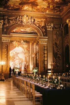 an elaborately decorated hall with tables and chairs