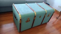 a blue suitcase sitting on top of a hard wood floor