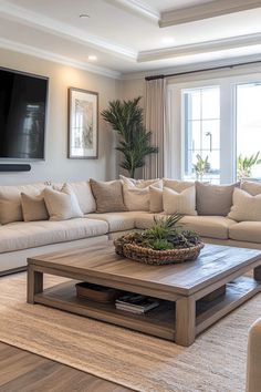 a living room filled with furniture and a flat screen tv mounted on the wall above it