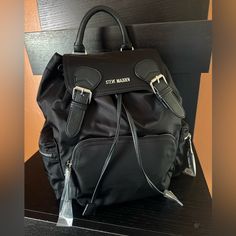 Nwt Steven Madden Medium Bsolly Backpack D0328735 Black Nylon Silver Logo Wide Straps Zipped Pockets $118 New With Tag Same Day Shipping Smoke And Pets Free This Stylish Backpack From Steve Madden Is Perfect For Everyday Use. With A Solid Black Exterior Made Of Nylon And Silver Hardware Accents, It's Both Practical And Fashionable. The Bag Features A Zip And Magnetic Closure, Adjustable Straps, And Multiple Pockets For Storage. Measuring 17 Inches In Width, 12 Inches In Height, And 7 Inches In D Everyday Backpack Women, Steve Madden B Vital Bag, Steve Madden Shoulder Bag, Steve Madden Bags Handbags Totes, Steve Madden Burgent Bag, Steve Madden Backpack, Stylish Backpack, Everyday Backpack, Medium Sized Bags