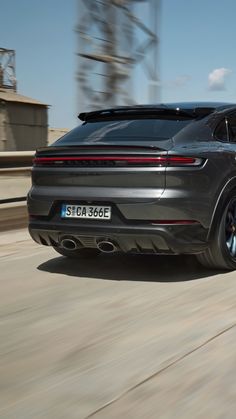 a grey porsche cayen driving down the road