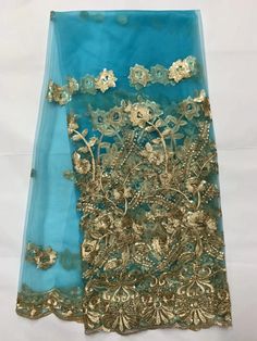 two pieces of blue and gold embroidered fabric