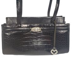 Brighton Purse Handbag Shoulder Bag Black Leather Croc Embossed Brighton Collection 218709 Double Handle, 11.5" Drop Faux "Buckle" Medallion and Heart Charm Magnetic Snap Closure Approximately 12" Wide x 6" Tall x 3.5" Deep Structured, Reinforced Base to Maintain Shape Very good pre-owned condition. No scratches, stains, or other flaws detected. See photos for condition details. Calculated shipping (weight, dimensions, distance) from smoke-free home. Vintage Black Bag With Cc Turnlock Closure, Vintage Brighton Handbags, Brighton Purses, Brighton Charm Bracelet, Brighton Handbags, Black Leather Bag With Silver-tone Hardware, Brighton Bags, Handbag Black, Black Leather Handbags