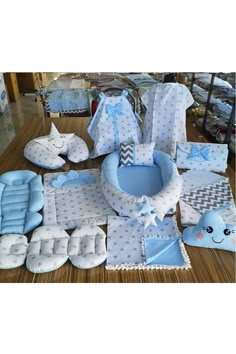 a baby's blue and white gift set with matching blankets, booties, bibs, diapers, mitts and more