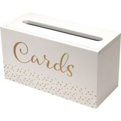 a white card box with gold dots and the word cards on it's side