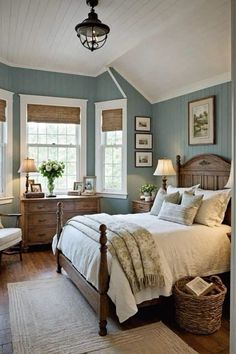 a bedroom with blue walls and white bedding, two windows in the ceiling, wooden furniture