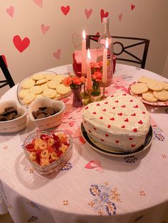 a table topped with lots of cakes and cookies