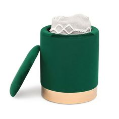 a roll of toilet paper sitting on top of a green container with a white napkin in it