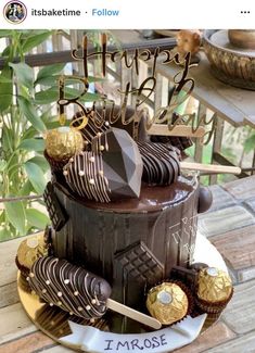 a birthday cake with chocolate frosting and gold decorations