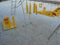 there is a yellow swing set on the ground