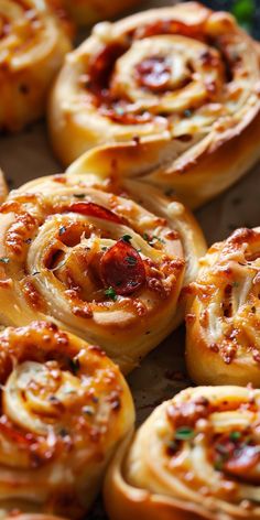 many small pastries are sitting on a baking sheet