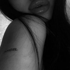 a close up of a person with a tattoo on her arm