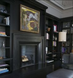 a living room filled with furniture and a fire place in the middle of a room