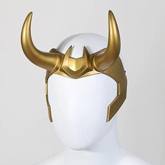 a white mannequin head with gold horns on it