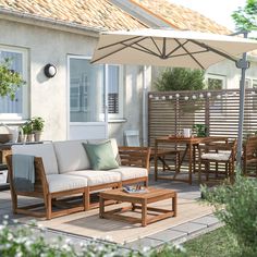 an outdoor living area with patio furniture and umbrella