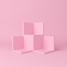 three pink cubes sitting on top of each other in front of a pink background