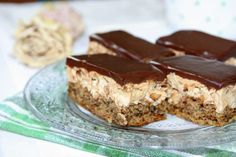 chocolate and peanut butter bars on a glass plate