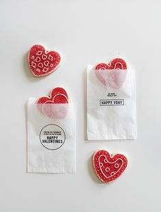 three valentine's day treats are on paper bags