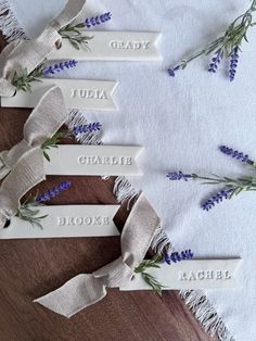 three name tags with lavender flowers on them