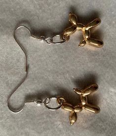 These amazing dangle/drop balloon dog earrings are handmade to order. The earrings are made from resin. These fun and quirky earrings will look stunning in anyone's collection. There are 2 options to choose from: silver dog, rose gold dog They are a perfect small gift for yourself, family or friends. They are lead and nickel free making it safe to wear on a daily basis. Come well presented on a suitable earring card, placed in an organised bag and then wrapped in decorative paper. We aim to get Gold Novelty Dangle Jewelry, Gold Novelty Drop Earrings, Quirky Dangle Earrings For Gift, Everyday Novelty Dangle Earrings, Handmade Quirky Drop Earrings, Quirky Earrings, Dog Earrings, Balloon Dog, Animal Earrings