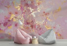 two bean bags sitting on the floor in front of a pink and gold painted wall