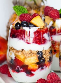 fruit and yogurt parfait in glasses with fresh berries on the side