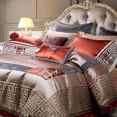 a bed with an ornate headboard and pillows