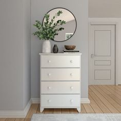 a white dresser with a mirror on it and a plant sitting on top of it