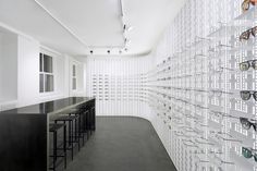 an eye store with rows of glasses on the wall