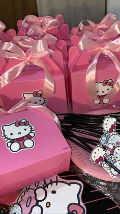 pink hello kitty boxes with bows and stickers on them