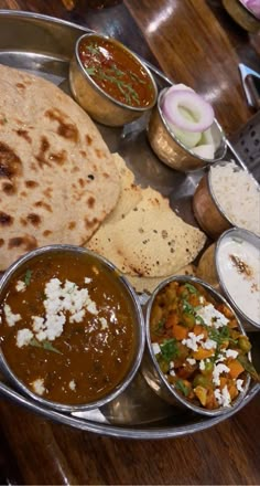 a metal plate topped with different types of food