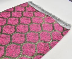 a pink and brown patterned cloth on a table