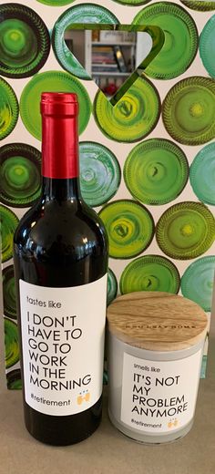 a bottle of wine next to a jar of ice cream on a counter top with a wallpaper behind it