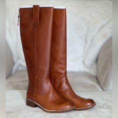 Knee High Sofft Samantha Cognac Boot Size 7. New In Box. Never Worn. 1in Heel. Circumference 14.5 In. Shaft 17in. Stride Into Autumn With Knee-High Brown Boots That Whisper Tales Of Fall Fashion. These Boots, Crafted From Earth-Toned Leather, Are Designed For The Crisp Days When Leaves Crunch Underfoot. With A Sturdy Yet Stylish Build, They're Perfect For Navigating Both Pumpkin Patches And Bustling City Streets. Elegantly Rising To The Occasion, They Pair Flawlessly With Soft Woolen Scarves And Cognac Color Boots, Cognac Womens Boots, Congnac Boots, Sofft Boots, Tall Brown Suede Boots, Brown High Boots, Tall Brown Leather Boots, Tall Heeled Boots, Cognac Boots