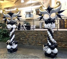 two black and white balloon sculptures in front of a building