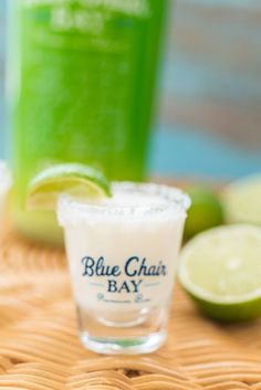 the blue chai bay cocktail is garnished with limes