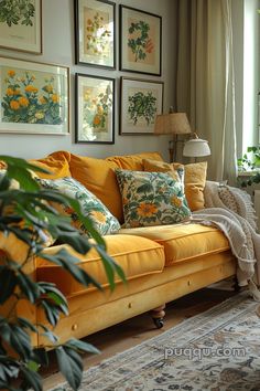 a living room with yellow couches and pictures on the wall above them, along with potted plants